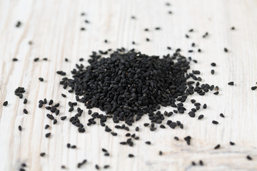 black cumin on wooden surface