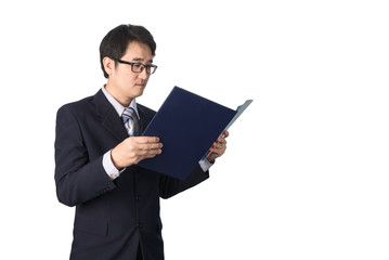 Asian businessman reading important information in file folder,