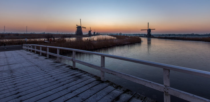 The famous windmills of Kinderdijk during a freezing sunrise