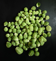 Fresh Brussels sprouts on black background