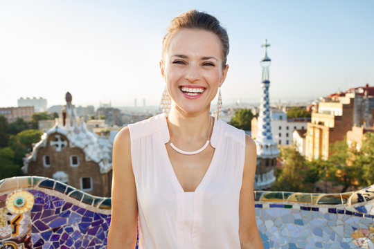 Smiling young woman tourist in Park Guell, Barcelona, Spain