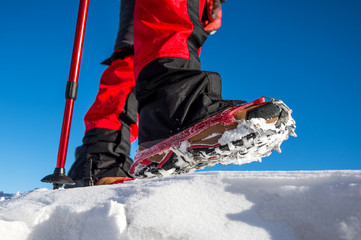 View of walking on snow with Snow shoes and Shoe spikes in winte