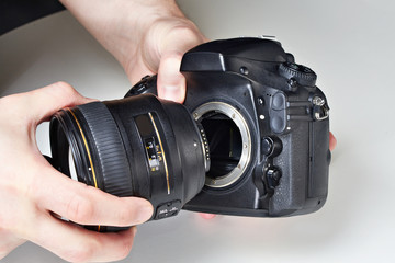Photographer with big lens and digital SLR camera