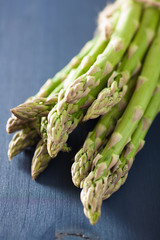 bunch of fresh asparagus on blue background