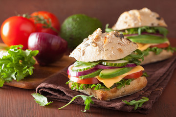 tomato avocado cheese sandwich with cucumber onion