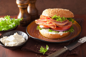 ham sandwich on bagel with cream cheese tomato onion