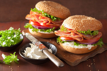 ham sandwich on bagel with cream cheese tomato onion