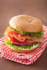 ham sandwich on bagel with cream cheese tomato onion