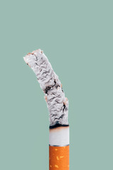 Cigarette burning on green background