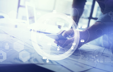 Business concept of businessman using smartphone. Architectural project on the table. Digital interface, horizontal mockup.