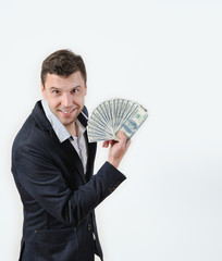 Businessman with bundle of money on a white background