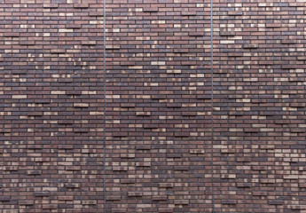 Texture of brown and beige brick wall.