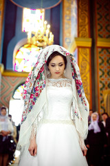 elegant stylish bride with floral kerchief in old church, weddin