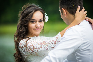 Obraz premium stylish gorgeous happy brunette bride and elegant groom on the p