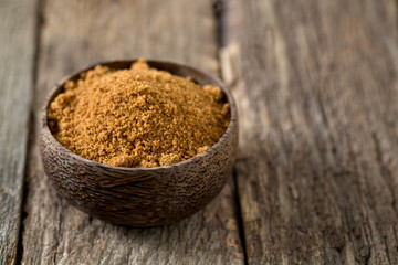 coconut palm sugar on wooden surface