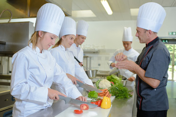 Chef watching trainees at work