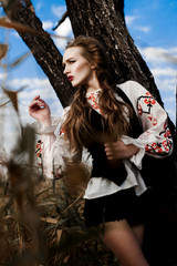 Young girl on the summer field  in national Belarus clothes, fas