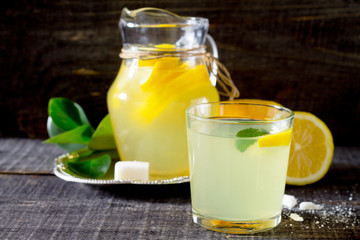 A drink with fresh lemon on a wooden table