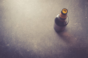 Naklejka na ściany i meble Beer bottle on dark table