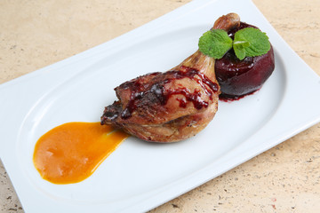 Roasted duck leg baked with apple in red wine
