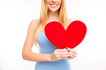 Cheerful young  girl holdind big paper heart, close up photo
