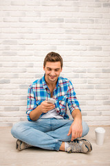 Cute young boy siting with crossed legs and chating