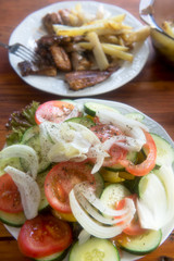 Fried potatoes, salad and fish - hake