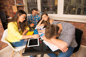Fototapeta premium Tired young people working together in office