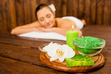 Obraz na płótnie Canvas happy woman relaxes at a spa salon with cosmetics