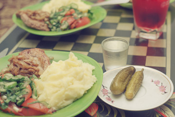 Salt cucumbers, potato, fried meat, salad from fresh cucumbers a