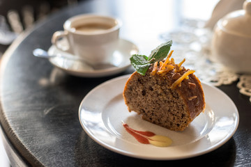 coffee cup with cake on table in cafe