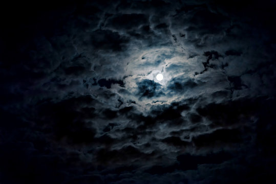 Night sky with full moon and mystic clouds. Spooky midnight, horror concept.
