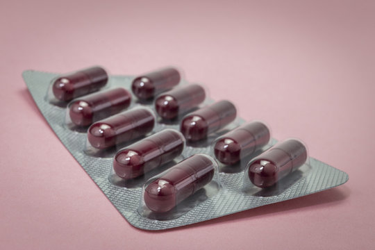 pills capsules medicine on pink background