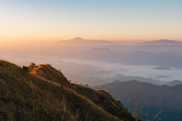 Bright sun shining over the golden mountain with view of mountain range background, mountain gap at Doi Tu Lay (mon Tu Lay) , Tak province Thailand