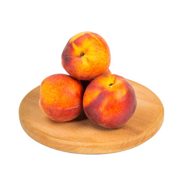 Peach fruits on wooden board - isolated on white background cutout