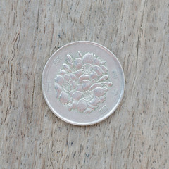  Japanese coins on wooden background