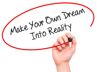 Man Hand writing Make Your Own Dream Into Reality with black mar