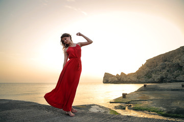 Beautiful woman dancing in front of the sea