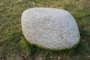 big solid soapstone lying in the grass