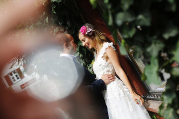 Joyful bride and groom embracing outdoor