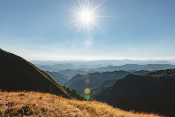 Bright sun shining over the green mountain with view of mountain range background, mountain gap at Doi Tu Lay (mon Tu Lay) , Tak province Thailand