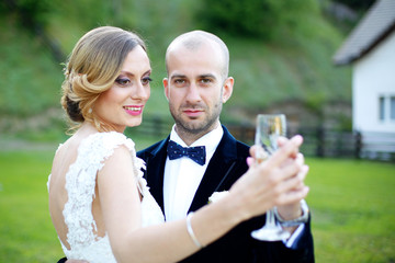 Joyful bride and groom embracing outdoor