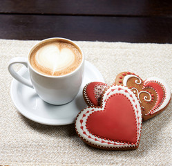 Joy of morning. Cropped closeup of a Valentine’s day coffee and cookies with red glaze covering