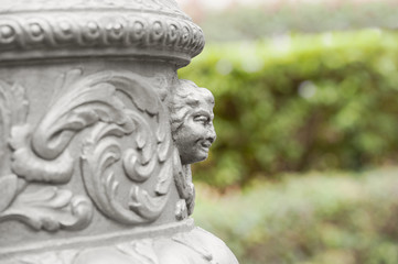 Obraz premium Fragment of decorative head column sculpture on a blurred background