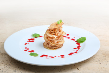 Pieces of roasted meat with pear chips