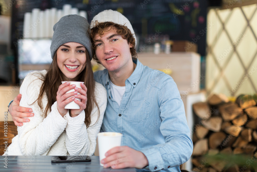 Wall mural Couple having hot drink on winter day
