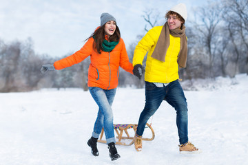 Couple with sled in snow