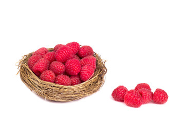 Raspberries in a basket on white background