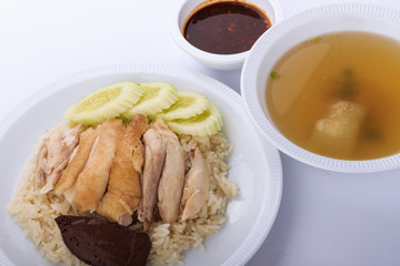 Hainanese chicken rice, steamed chicken, chicken blood and white rice on white background.