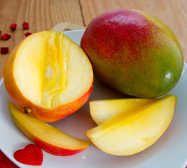 Naklejka na ściany i meble Mango fruit on wooden background.